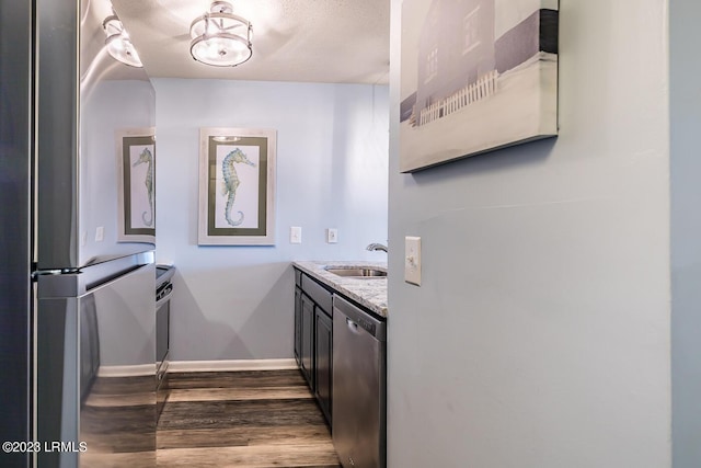 interior space featuring hardwood / wood-style flooring, vanity, and a textured ceiling