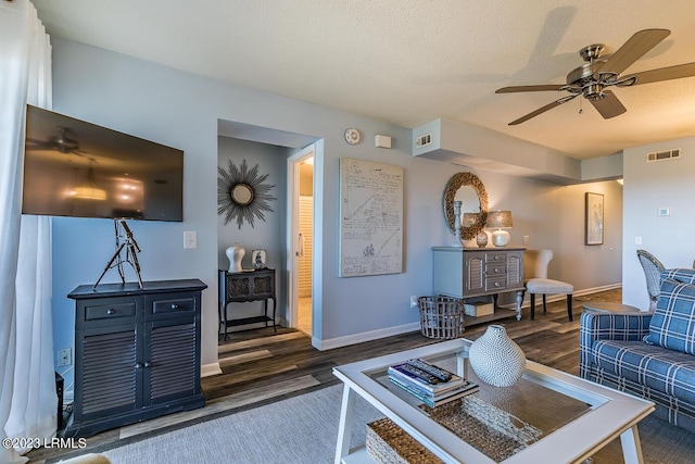 living room with ceiling fan and dark hardwood / wood-style floors