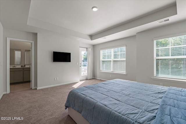 86 Slater St, Bluffton, SC 29909 - bedroom featuring a tray ceiling, light carpet, connected bathroom, and access to outside