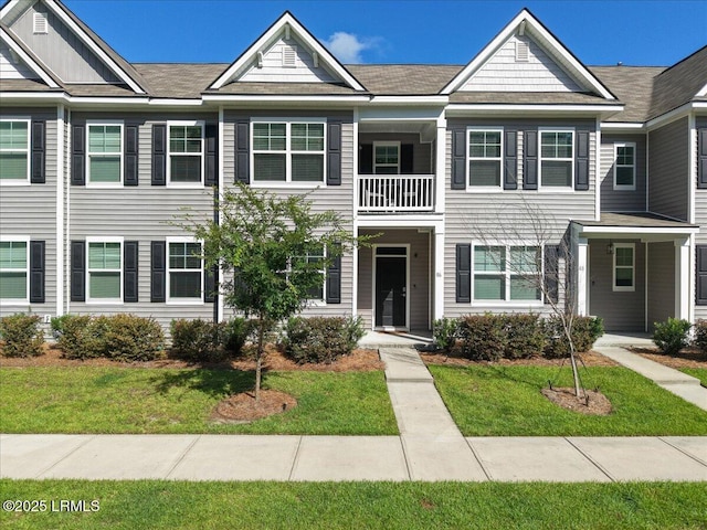 86 Slater St, Bluffton, SC 29909 - view of property featuring a balcony and a front lawn