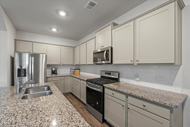 86 Slater St, Bluffton, SC 29909 - kitchen with stainless steel appliances, dark wood-style flooring, tasteful backsplash, and light stone countertops