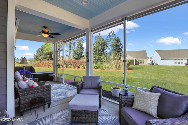 sunroom / solarium with a ceiling fan