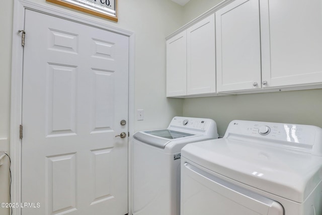 laundry area featuring cabinet space and washer and clothes dryer