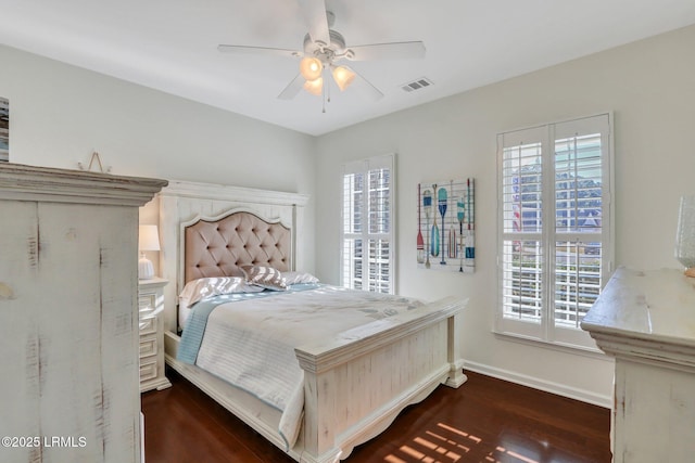 bedroom featuring visible vents, a ceiling fan, baseboards, and wood finished floors