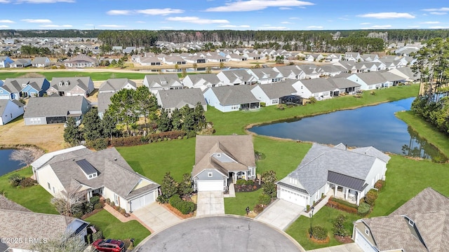 drone / aerial view featuring a residential view and a water view