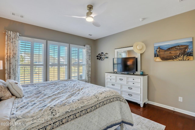 bedroom featuring baseboards, visible vents, dark wood-style flooring, and ceiling fan