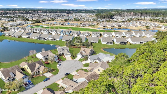 drone / aerial view with a residential view and a water view