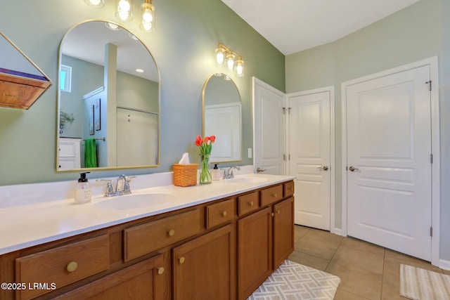 full bathroom with tile patterned flooring, double vanity, and a sink