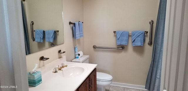 bathroom featuring vanity, tile patterned floors, and toilet