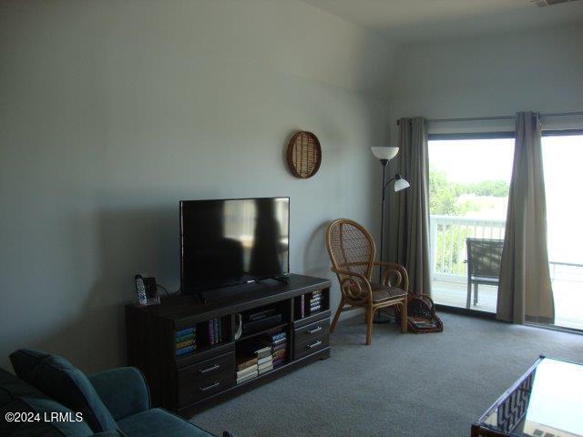 carpeted living room with vaulted ceiling