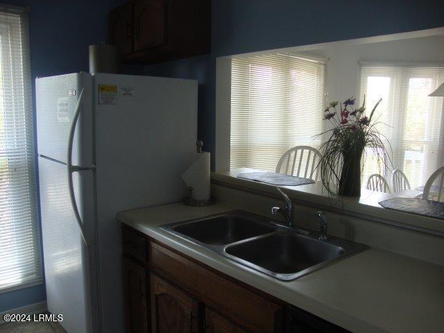 kitchen featuring white fridge and sink