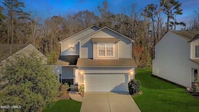 view of front of property featuring a garage, a front yard, concrete driveway, and stone siding