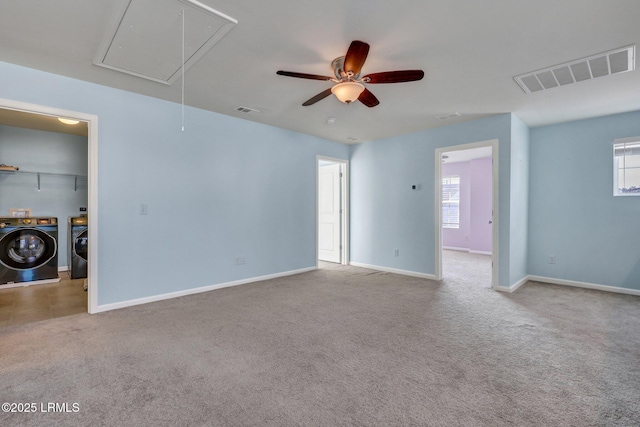 unfurnished room with carpet, attic access, visible vents, and independent washer and dryer