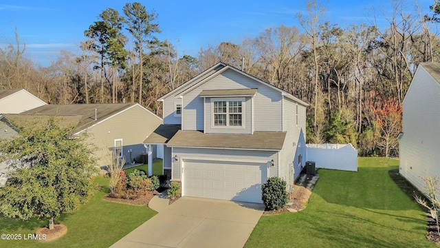 traditional home with driveway, an attached garage, fence, central air condition unit, and a front lawn