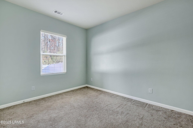 carpeted empty room with baseboards and visible vents