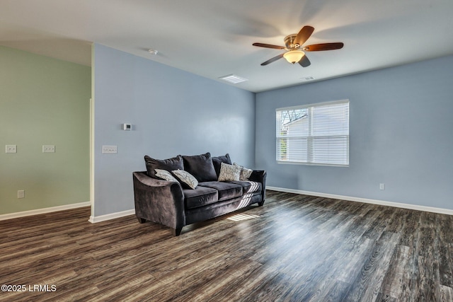 living room with ceiling fan, dark wood-style flooring, visible vents, and baseboards