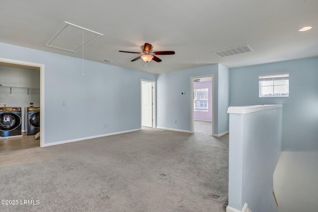 spare room featuring attic access, visible vents, baseboards, and washing machine and clothes dryer