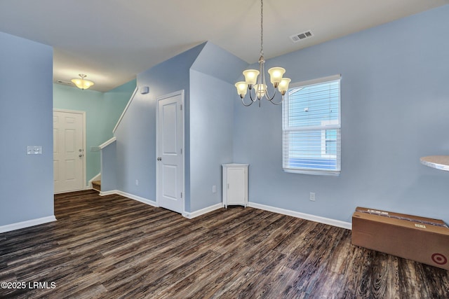 unfurnished room with baseboards, stairs, visible vents, and wood finished floors