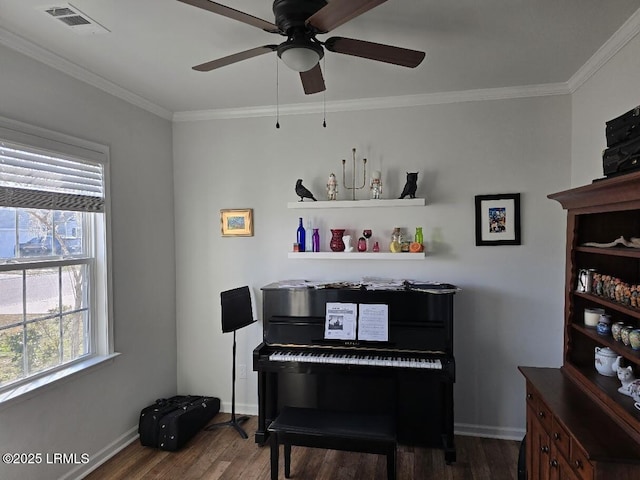 living area featuring dark wood-style floors, baseboards, visible vents, and crown molding