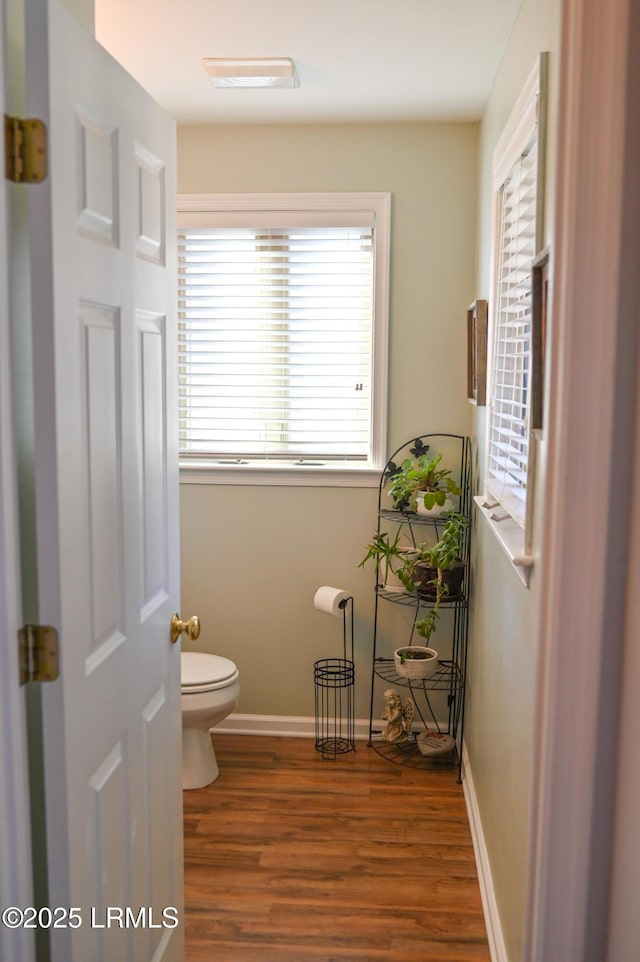 bathroom featuring hardwood / wood-style flooring and toilet