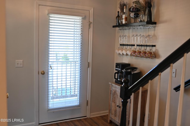 doorway featuring dark wood-type flooring and bar