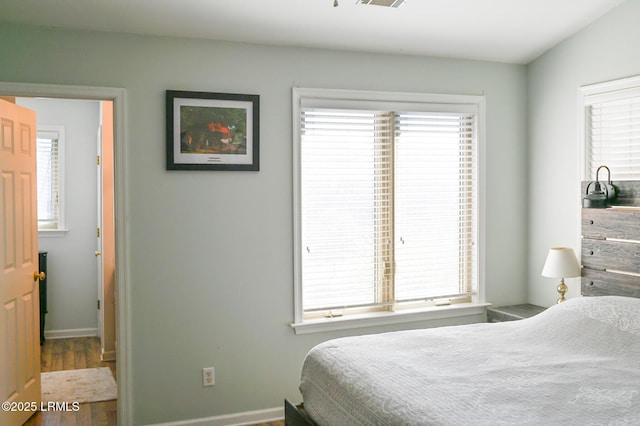 bedroom with hardwood / wood-style flooring