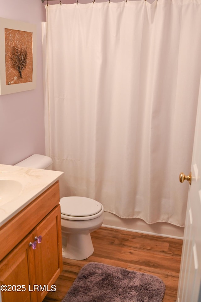 full bathroom with vanity, toilet, wood-type flooring, and shower / bath combo