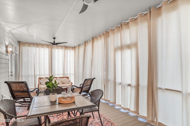 sunroom / solarium featuring ceiling fan