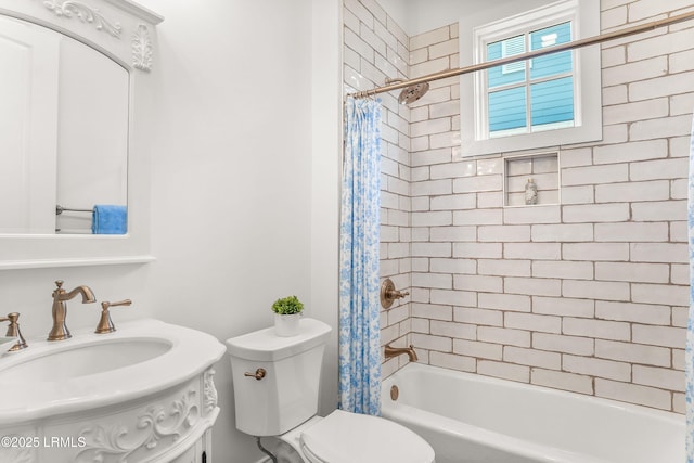 full bathroom featuring toilet, shower / bath combo, and a sink