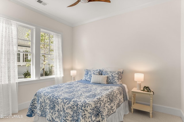 bedroom with light colored carpet, visible vents, a ceiling fan, ornamental molding, and baseboards