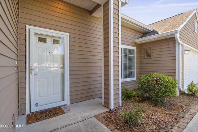 22 Purry Cir, Bluffton, SC 29909 - property entrance featuring a shingled roof and a garage