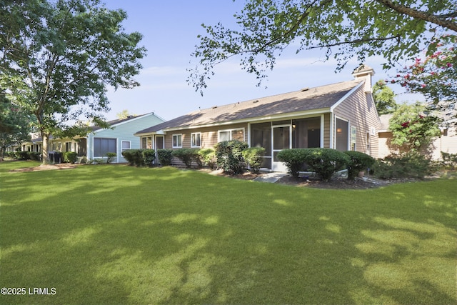 22 Purry Cir, Bluffton, SC 29909 - rear view of property featuring a lawn, a sunroom, a chimney, and roof with shingles