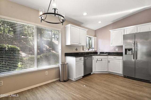 22 Purry Cir, Bluffton, SC 29909 - kitchen with stainless steel appliances, plenty of natural light, light wood finished floors, a chandelier, and lofted ceiling