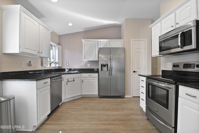 22 Purry Cir, Bluffton, SC 29909 - kitchen featuring stainless steel appliances, white cabinets, vaulted ceiling, light wood-type flooring, and recessed lighting