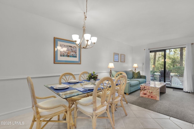 tiled dining space featuring a notable chandelier