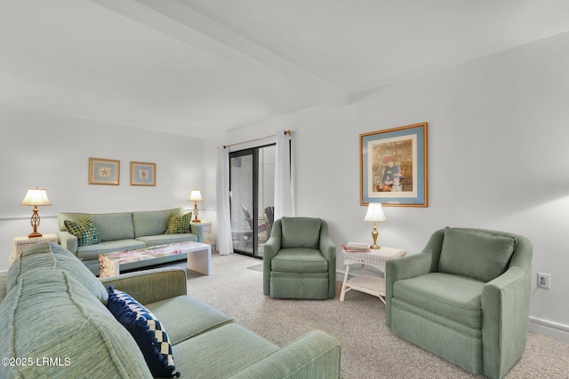 carpeted living room with beamed ceiling