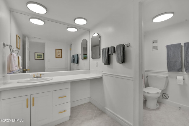 bathroom with vanity, tile patterned floors, and toilet