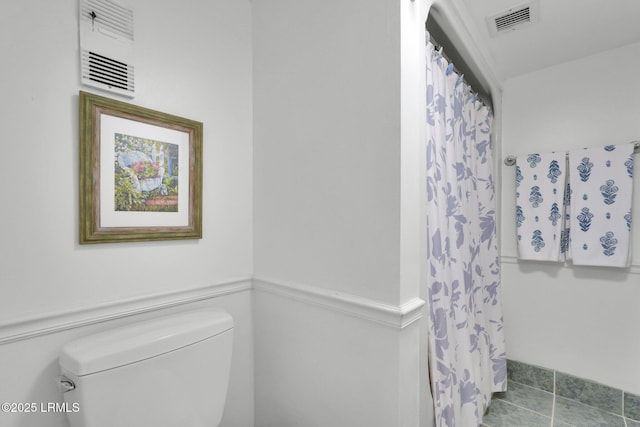 bathroom featuring tile patterned flooring and toilet