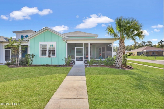 view of front of property with a front lawn and a sunroom