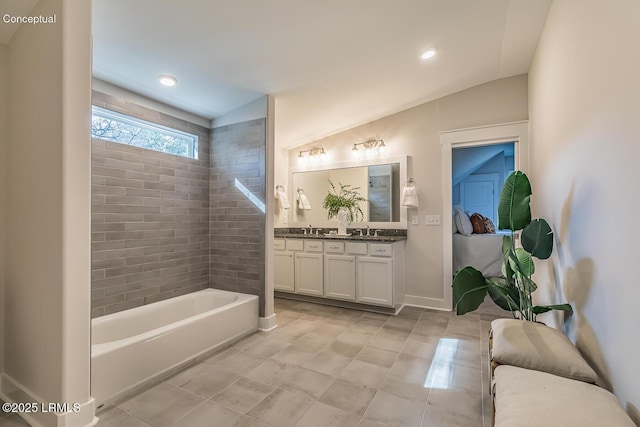 32 Faculty Dr, Beaufort, SC 29907 - bathroom featuring a tub to relax in, vanity, and vaulted ceiling