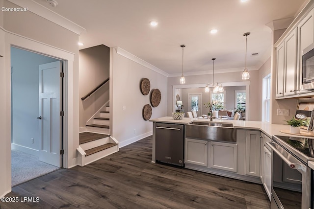 32 Faculty Dr, Beaufort, SC 29907 - kitchen featuring appliances with stainless steel finishes, pendant lighting, white cabinetry, sink, and kitchen peninsula