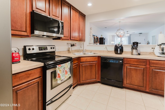 kitchen featuring pendant lighting, sink, light tile patterned floors, appliances with stainless steel finishes, and a chandelier