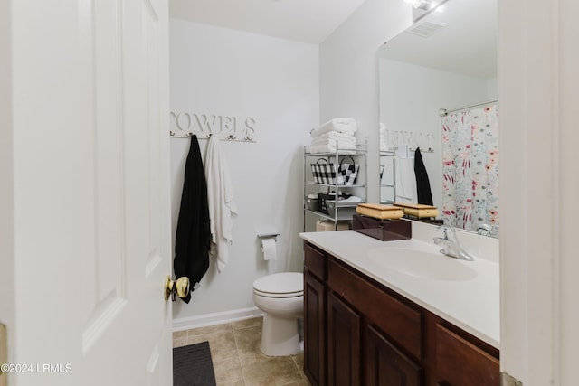 bathroom featuring tile patterned flooring, vanity, and toilet