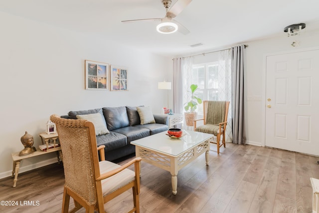 living room featuring ceiling fan and light hardwood / wood-style flooring