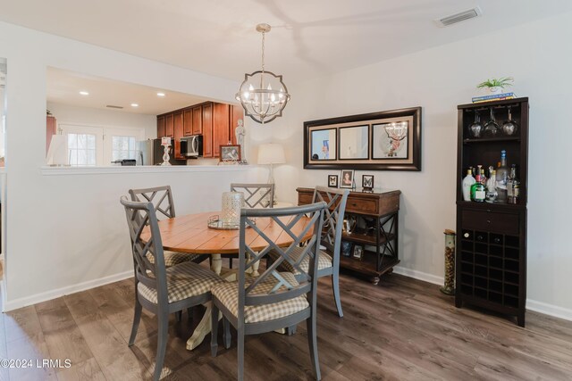 dining room featuring an inviting chandelier and dark hardwood / wood-style floors