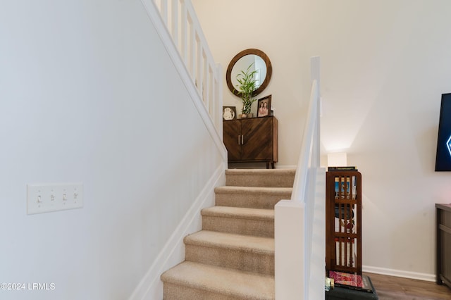 stairway featuring hardwood / wood-style flooring