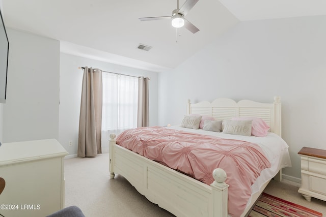 carpeted bedroom with ceiling fan and vaulted ceiling