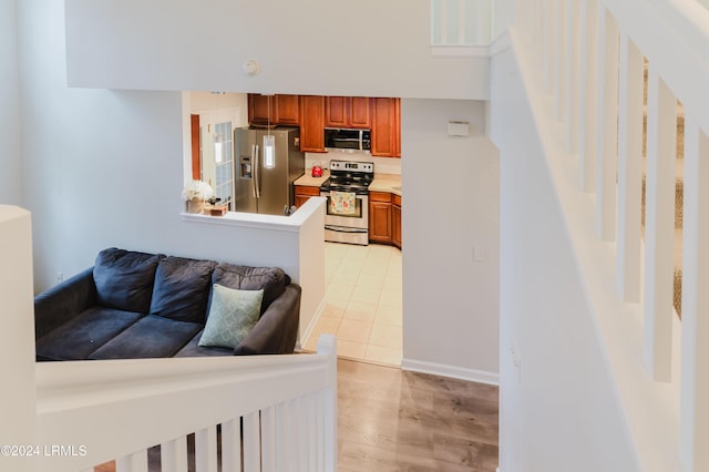 kitchen with light hardwood / wood-style flooring and stainless steel appliances