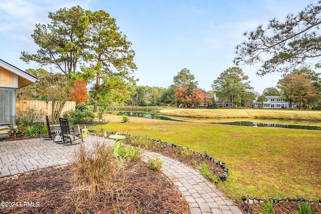 view of yard featuring a patio and a water view