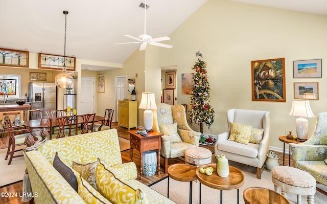 living room with hardwood / wood-style flooring, high vaulted ceiling, and ceiling fan